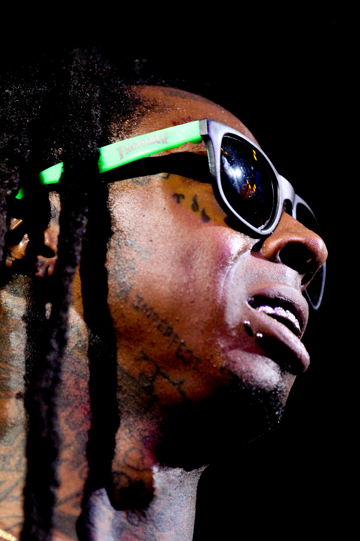 Close up portrait of Lil Wayne performing on stage with dramatic lighting photographed by Ebis Hernandez