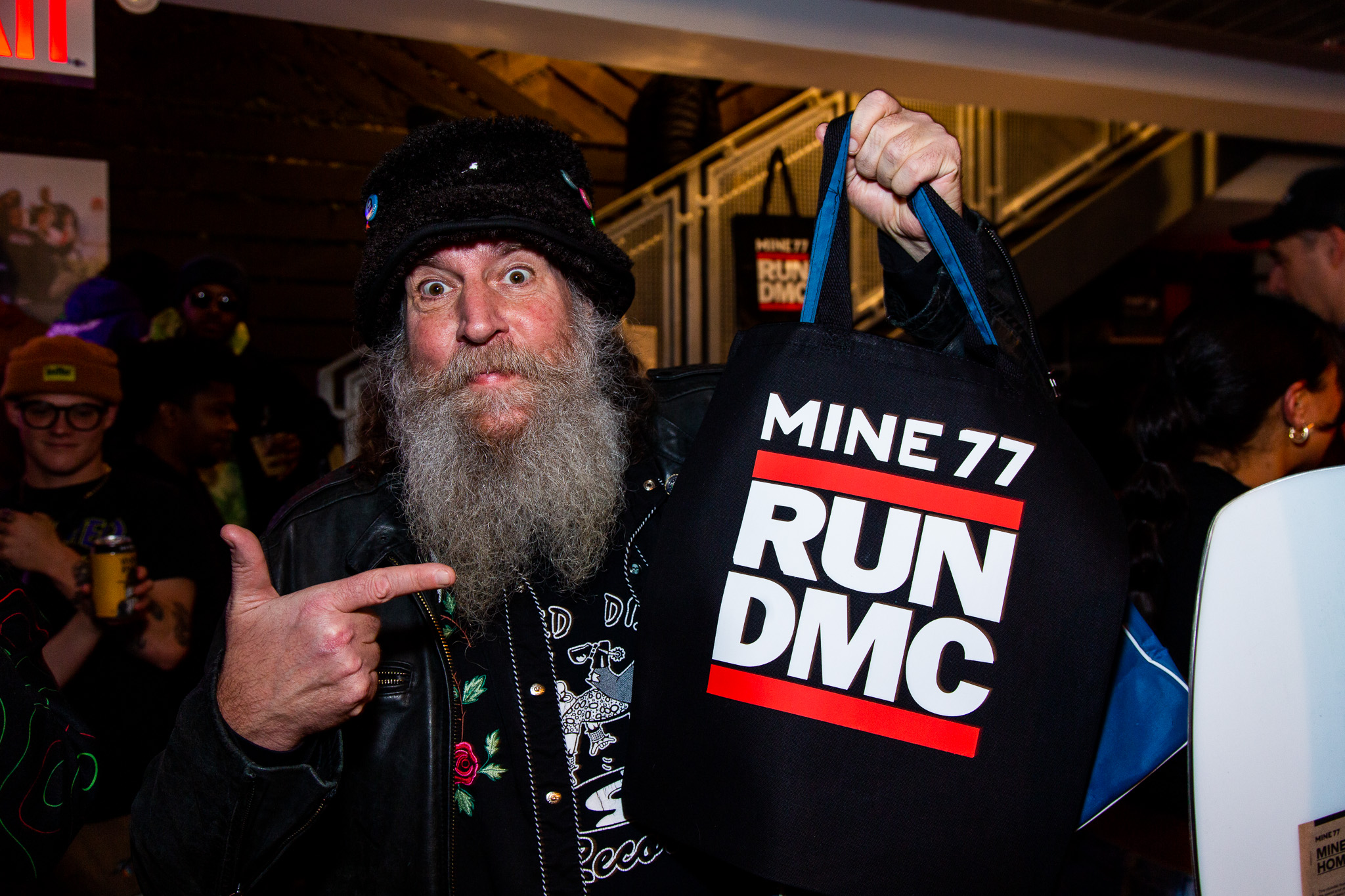 Event attendee holding Burton x Run DMC branded merchandise at SoHo NYC flagship store event photographed by Ebis Hernandez