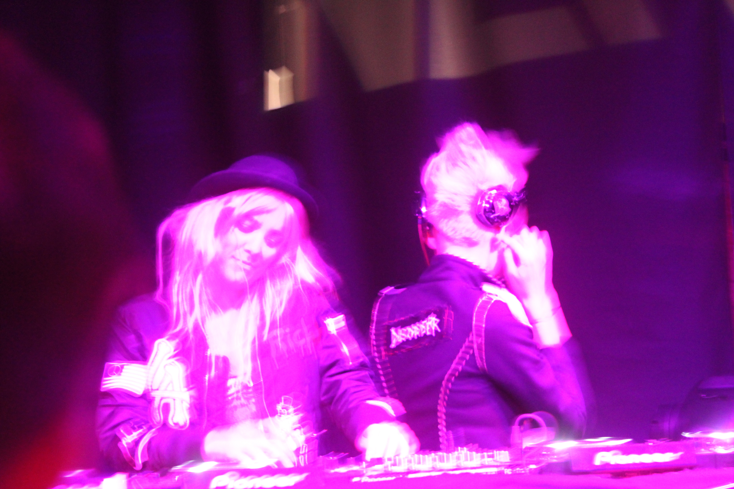 Female DJs performing in nightclub with colorful lighting during NYC nightlife event photographed by Ebis Hernandez
