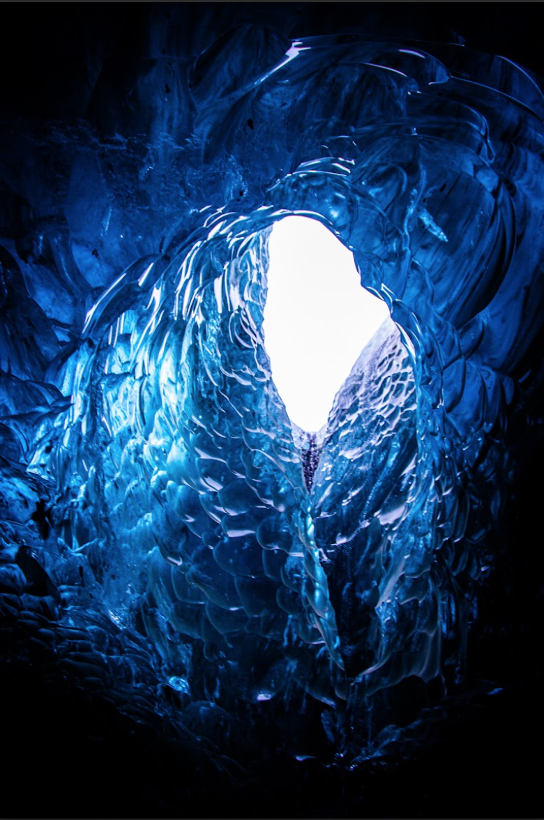 Natural ice arch formation glowing with blue tones, captured in the Frozen Beauty series by Ebis Hernandez