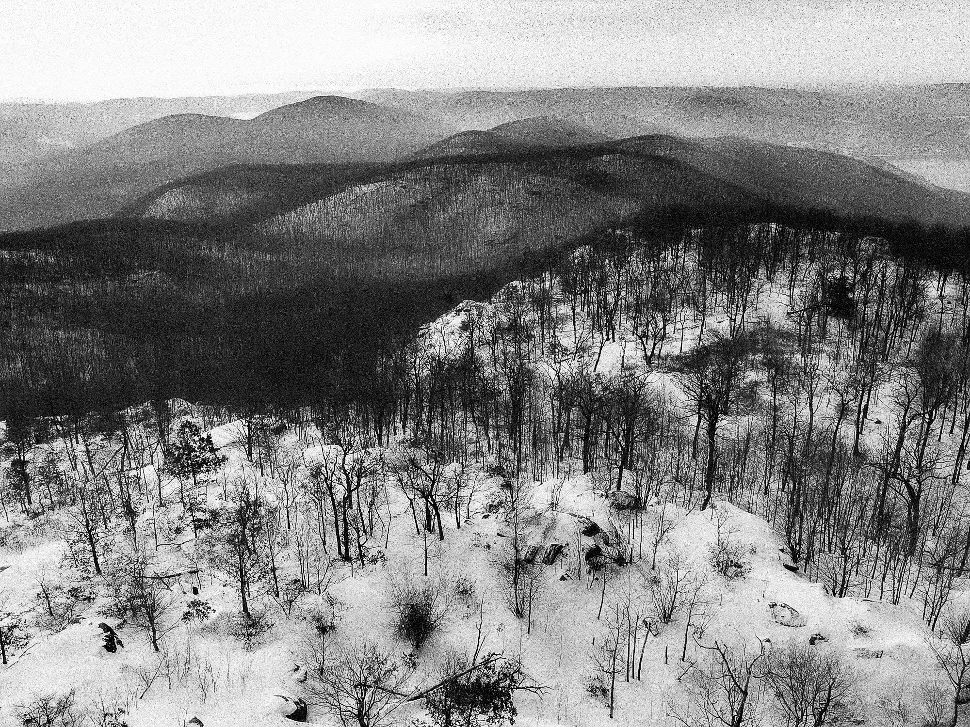Snow-covered mountain landscape captured in monochrome, emphasizing stillness and scale in the Frozen Beauty series