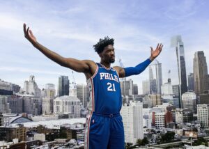 Joel Embiid portrait for Philadelphia 76ers with city skyline background photographed by Ebis Hernandez