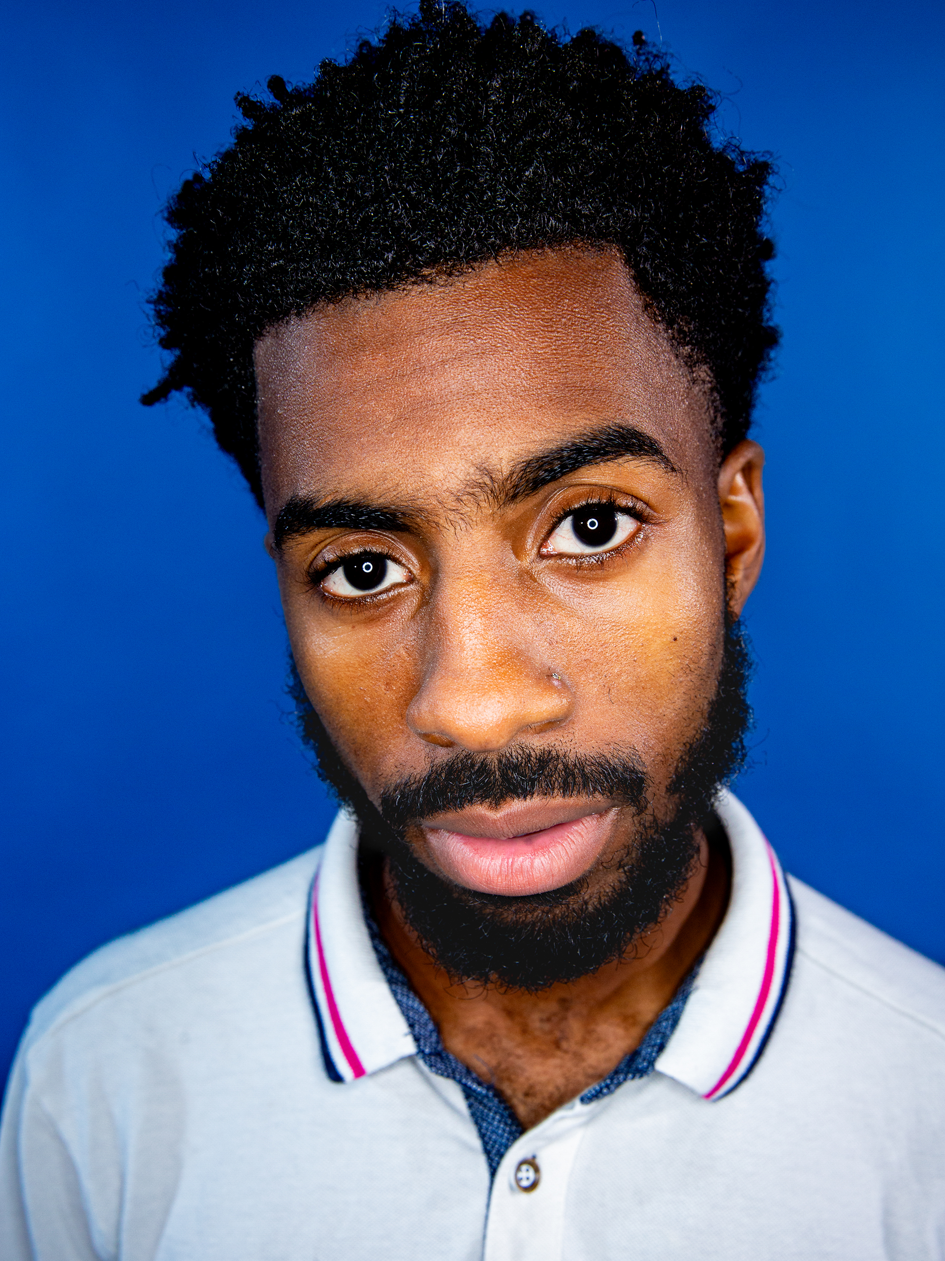 St. Cloud studio portrait with blue background by photographer Ebis Hernandez